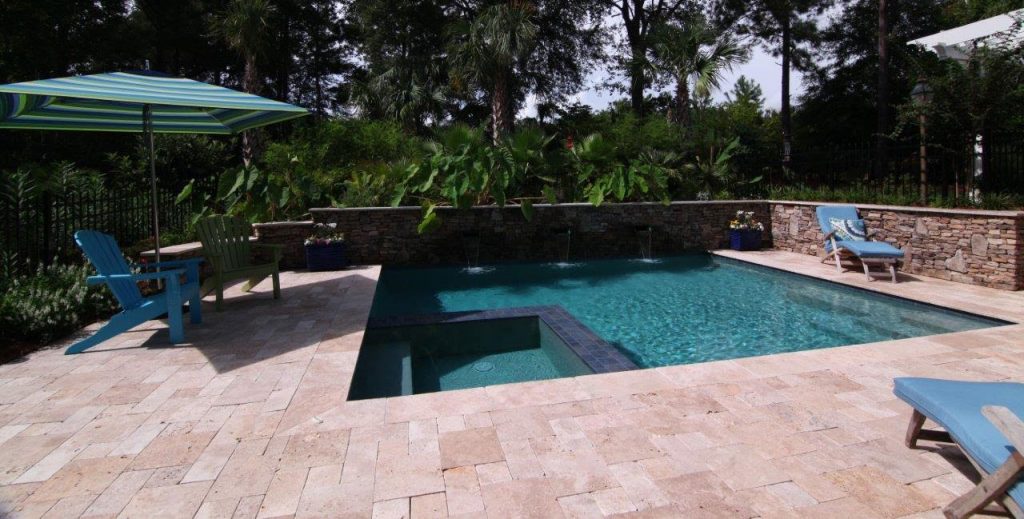 Pool with spa and a stone wall with waterfalls | Aqua Blue Pools