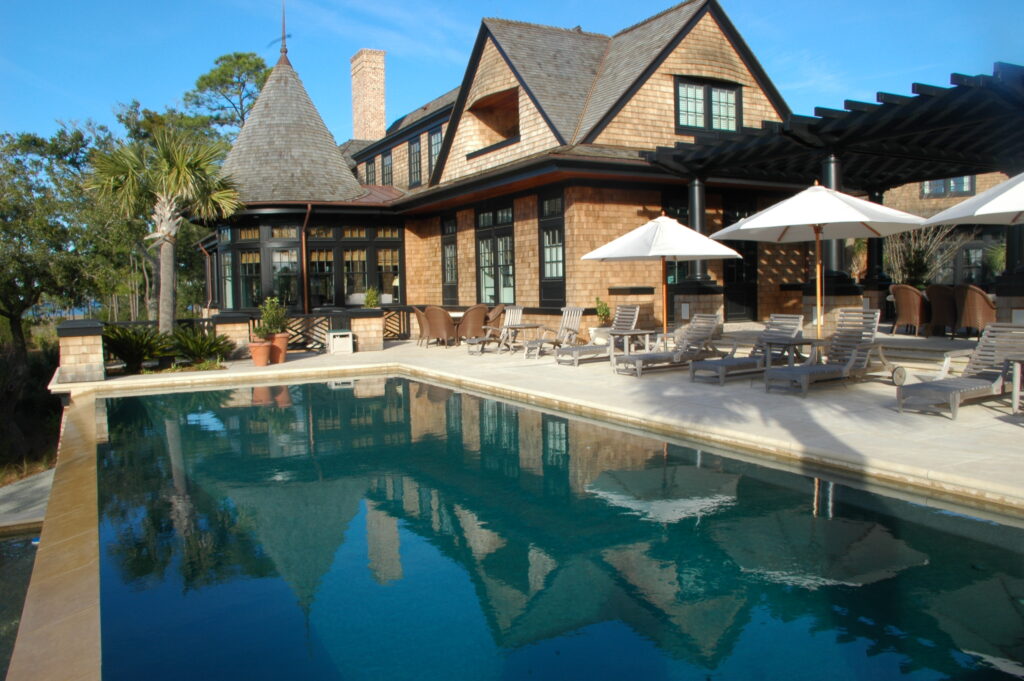 Backyard pool with a palm tree and outdoor furniture