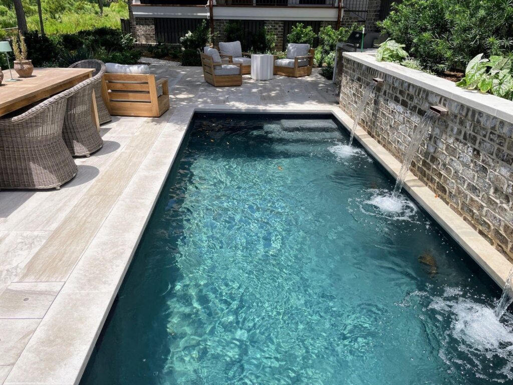 In-ground pool with hydraulic pool cover at Southern Living Idea House